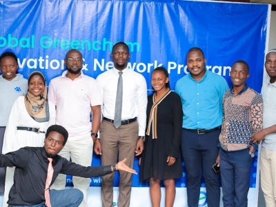 People posing for a group photo on a stage