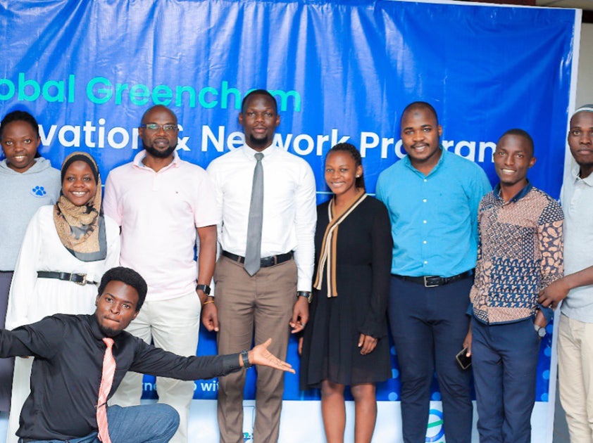 People posing for a group photo on a stage
