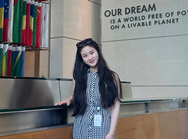 Woman in World Bank building atrium with flags in background