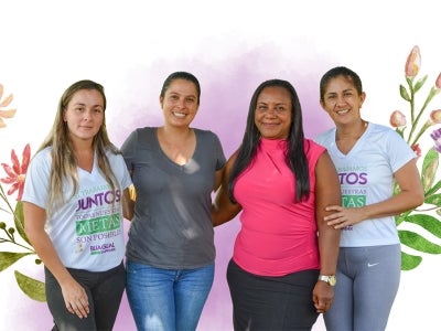 Four women posing for a group photo