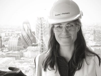 Woman with construction hat in a city scene, black and white