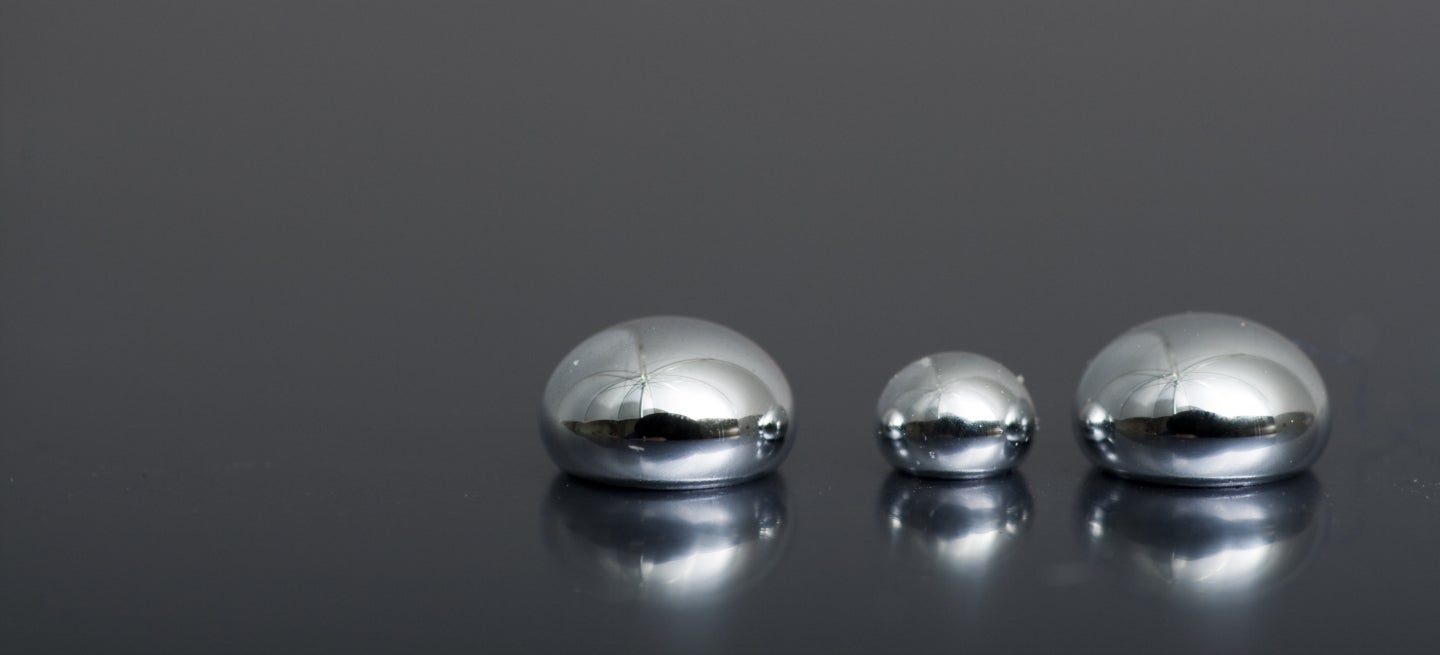 Droplets of mercury on a dark surface