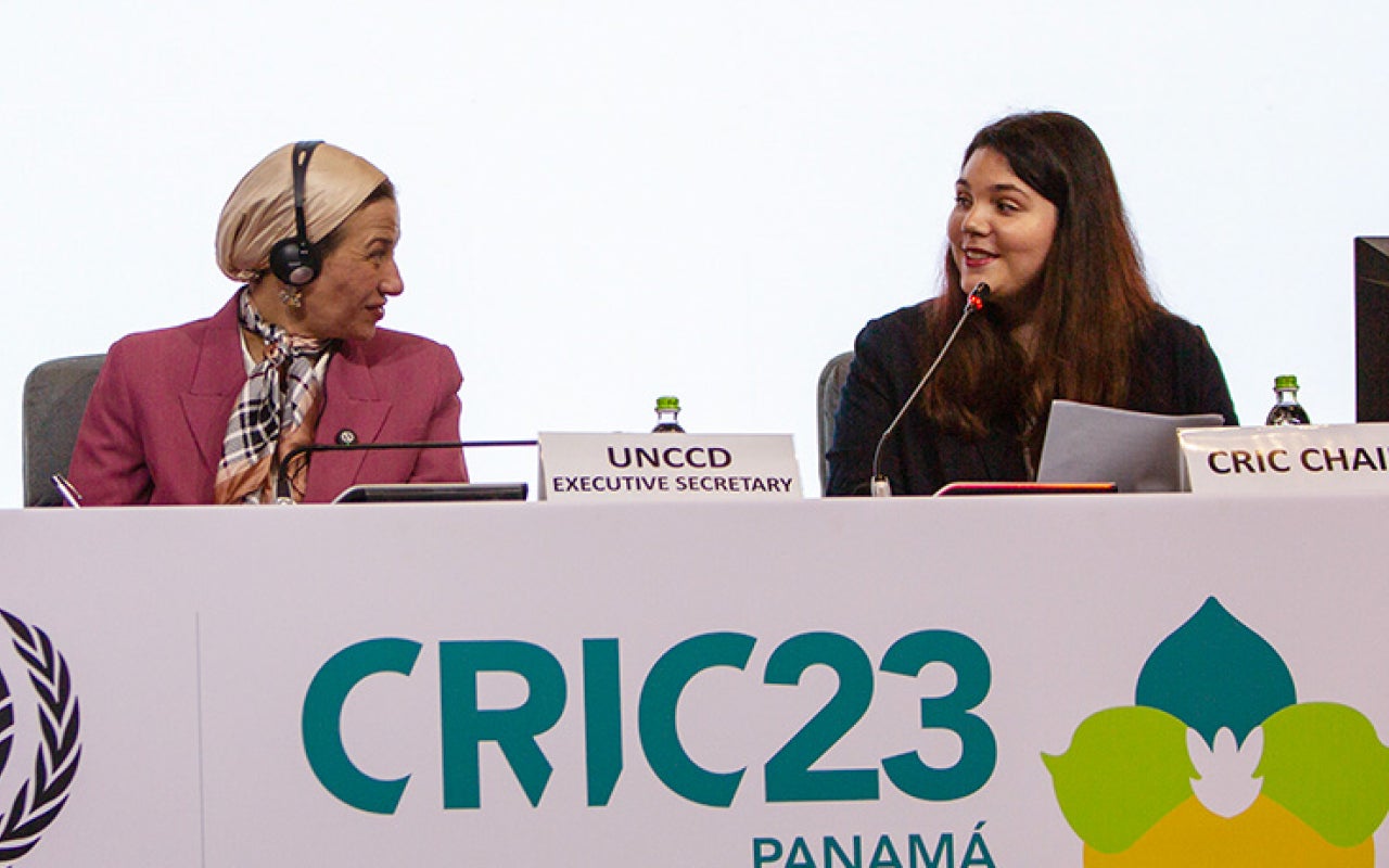 Two women speaking on a panel